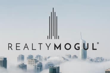 RealtyMogul logo stands proudly against a backdrop of foggy skyscrapers, inviting curious investors to explore its promising reviews.