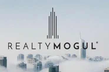 RealtyMogul logo stands proudly against a backdrop of foggy skyscrapers, inviting curious investors to explore its promising reviews.